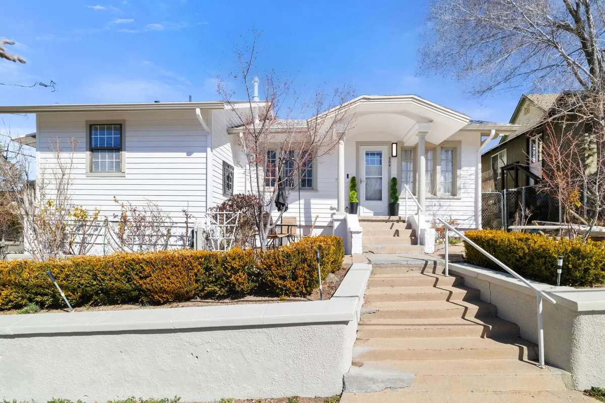 This image presents the front entrance of Emma’s Manor, showcasing landscaped steps and a welcoming front yard. The inviting porch, tidy landscaping, and classic Craftsman details evoke the charm of Prescott’s early 20th-century architecture.